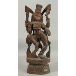 A 19TH CENTURY WOODEN CARVING OF SHIVA, 61cm high.