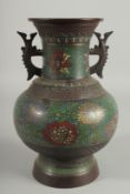 A CHINESE ENAMELLED BRONZE TWIN HANDLE VASE, the enamelled bands with decorative flora, base with