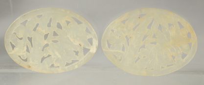 TWO CHINESE CARVED JADE AMULETS, 7cm x 5cm.