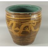 A VERY LARGE CHINESE EARTHENWARE GLAZED POTTERY JARDINIERE PLANTER, decorated with dragon, the