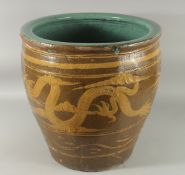 A VERY LARGE CHINESE EARTHENWARE GLAZED POTTERY JARDINIERE PLANTER, decorated with dragon, the