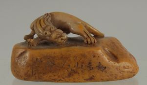 A 19TH CENTURY CHINESE SOAPSTONE SEAL, with carved chilong, 8.5cm long.