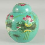 A CHINESE TURQUOISE GROUND PORCELAIN JAR AND COVER, 15cm high.