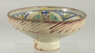 A 19TH CENTURY MOROCCAN POTTERY FOOTED BOWL, 23.5cm diameter.