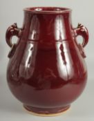 A CHINESE OX BLOOD GLAZE TWIN HANDLE VASE, 26cm high.