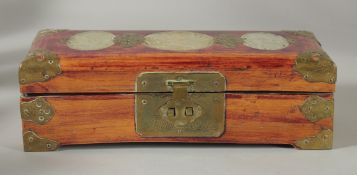 A CHINESE JADE INSET RECTANGULAR WOODEN BOX, with hinged lid and brass mounts, 25cm x 10cm.