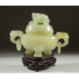 A CARVED JADE KORO AND COVER on a fitted wooden stand, with drop ring twin handles and carved foo