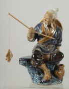 A CHINESE SHIWAN GLAZED POTTERY FIGURE OF A FISHERMAN, 19cm high.