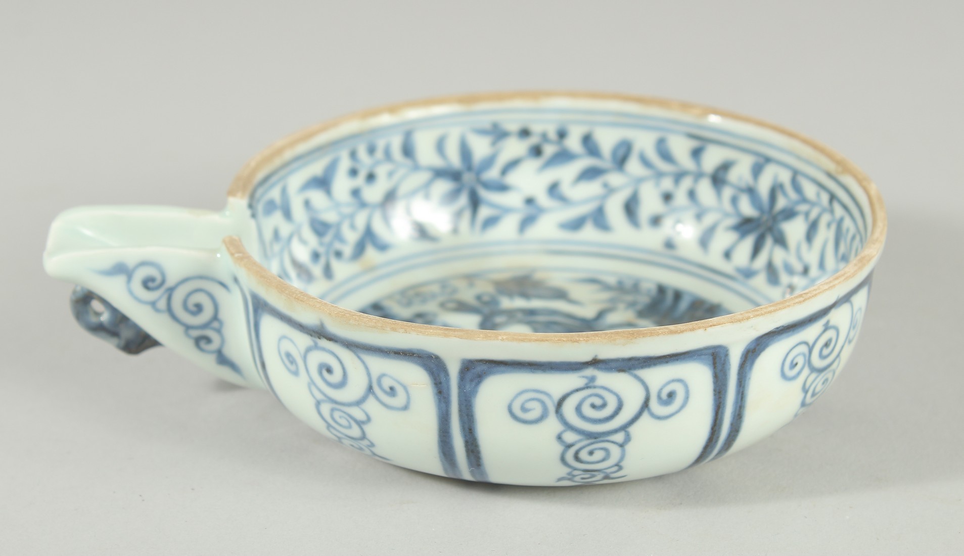 A CHINESE BLUE AND WHITE PORCELAIN OIL CUP, painted with a rabbit, 13cm diameter (excluding spout).