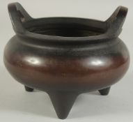 A CHINESE BRONZE TWIN HANDLE TRIPOD CENSER, 17cm diameter.