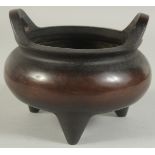 A CHINESE BRONZE TWIN HANDLE TRIPOD CENSER, 17cm diameter.