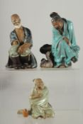 THREE CHINESE SHIWAN GLAZED POTTERY FIGURES, (two with loss), various sizes, (3).