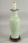 A CHINESE CELADON GLAZE PORCELAIN LAMP VASE, mounted to a hardwood base, (fitted for electricity but