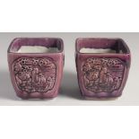 A PAIR OF EARLY 20TH CENTURY CHINESE PURPLE GLAZE FLOWER POTS, with panels of relief decoration