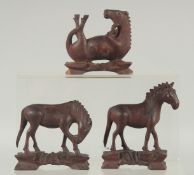 THREE CHINESE CARVED WOODEN HORSES, with inset eyes, (3).