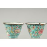 A PAIR OF CHINESE CANTON FAMILLE ROSE ENAMEL CUPS, 6cm diameter.