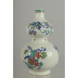 A CHINESE DOUCAI PORCELAIN DOUBLE GOURD VASE, painted with various fruits, 20.5cm high.