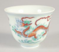 A CHINESE DOUCAI PORCELAIN DRAGON CUP, six-character mark to base, 6.5cm diameter.
