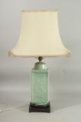 A CHINESE CELADON GLAZE SQUARE FORM VASE LAMP, mounted to a hardwood base, the vase with relief
