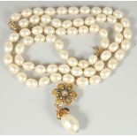 A VERY GOOD CHANEL LONG, LARGE PEARL NECKLACE, sixty six pearls with enamel pendant and large pearl.