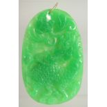 A CHINESE LARGE JADE PENDANT with gold ring. 3.25ins x 2.5ins.