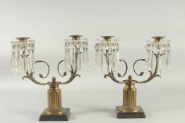 A PAIR OF 19TH CENTURY BRONZE AND CRYSTAL TWO LIGHT CANDELABRA with a pair of scrotting arms and