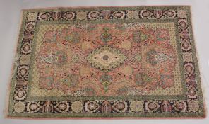 A PERSIAN PART SILK CARPET pink ground with sylised floral decoration within a similarly border.