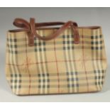 A BURBERRY SMALL HAND BAG, tartan pattern with leather brown straps, with navy dust cover. 32cm