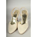 A PAIR OF CHANEL CREAM FABRIC SLING BACK SHOES. Size 38, boxed.