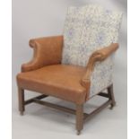 A GEORGE III MAHOGNAY GAINSBOROUGH ARMCHAIR with brass studs on straight legs with brass casters.