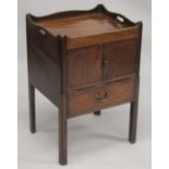 A GEORGE III MAHOGANY TRAY TOP BEDSIDE TABLE with hand apertures, the front with double panel