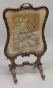 A VICTORIAN MAHOGANY FIRE SCREEN with Brussels tapestry.