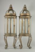 A LARGE PAIR OF COPPER ROUND LANTERNS on four curving legs.