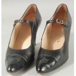 A PAIR OF CHANEL BLACK LEATHER SHOES with buckles and patent toes. Size 38.