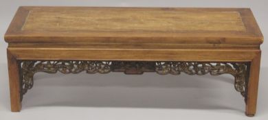 A CHINESE REDWOOD OPIUM TABLE 4ft long, 1ft4ins high.