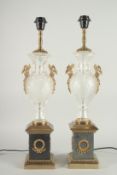 A GOOD PAIR OF REGENCY DESIGN CUT GLASS BRONZE AND GILT URN SHAPED LAMPS. 25ins high.