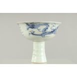 A CHINESE BLUE AND WHITE STEM CUP the sides with dragons. 4.5ins high.