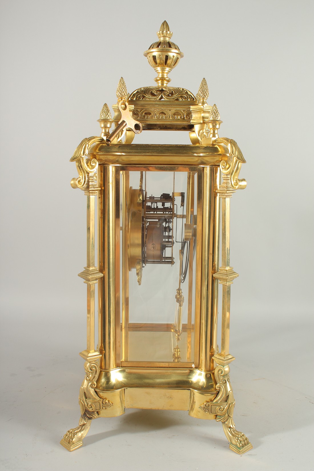 A GOOD GILT BRONZE FOUR GLASS CLOCK with pineapple finials on claw feet. 24ins high. - Image 3 of 5