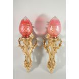 A GOOD PAIR OF LOUIS XVITH ORMOLU CORNET WALL LIGHTS with ruby shades. 24ins long.