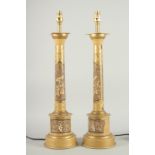 A PAIR OF CHINESE DESIGN COLUMN LAMPS. 23ins high.