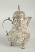 A GOOD CONTINENTAL SILVER COFFEE POT with all over repousse decoration supported on three claw feet.