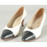A PAIR OF CHANEL LEATHER WHITE SHOES with navy toe. Size 37.5.