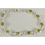 A SILVER PERIDOT SET BRACELET.