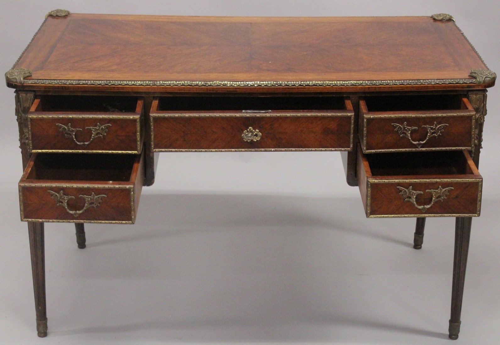 A LOUIS XVITH DESIGN WRITING TABLE with wooden top, five drawers on turned legs with ormolu - Image 6 of 7