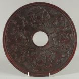 A LARGE CARVED CHINESE JADE DISC carved on both sides. 11.5ins diameter.