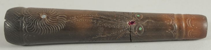 A RARE TAPERING PIPE, POSSIBLY MAORI, carved with faces, opal and sapphires. 5.75ins high.