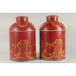 A LARGE PAIR OF TOLEWARE DESIGN TEA CANISTERS AND COVERS. 14ins high.