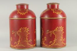 A LARGE PAIR OF TOLEWARE DESIGN TEA CANISTERS AND COVERS. 14ins high.