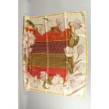 A CHRISTIAN DIOR SILK SCARF with panels and flowers, in original box. 87.5cm x 87.5cm.