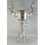 A LARGE PLATED STAG WINE COOLER ON A STAND. 3ft 6ins high.